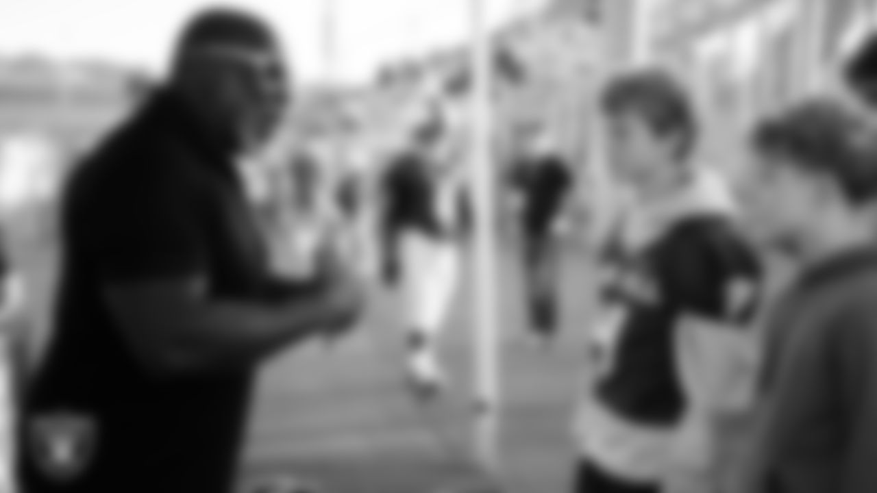 Las Vegas Raiders alumnus Roy Hart talks with students before the Las Vegas Raiders' Football Showcase game at Foothill High School.