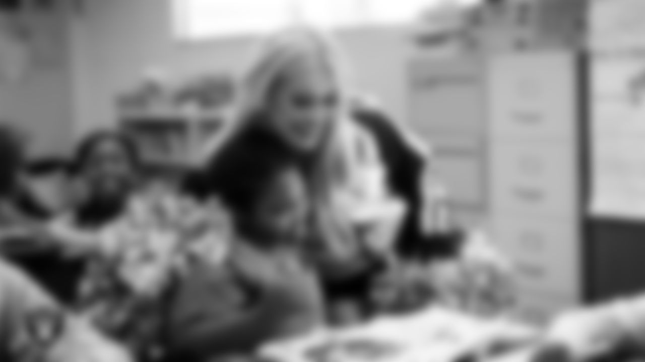 Raiderette Pip hugs a student during a 'Lil Raiders Pop-Up at Matt Kelly Elementary School.