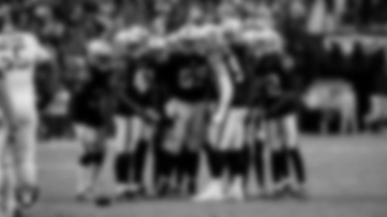 The Las Vegas Raiders defense huddles during the regular season home game against the Tennessee Titans at Allegiant Stadium.