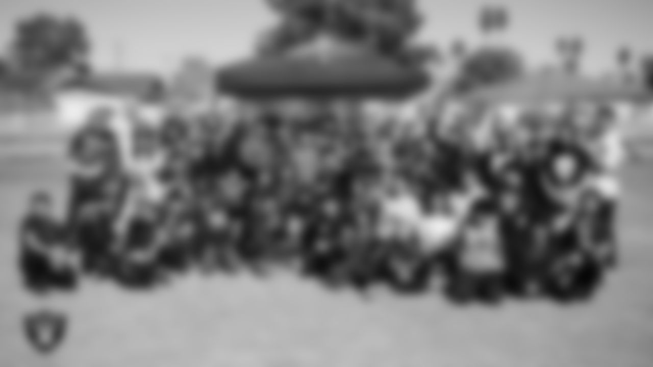 Students and staff pose for a photo during a Raiders Junior Training Camp at George E. Harris Elementary School.