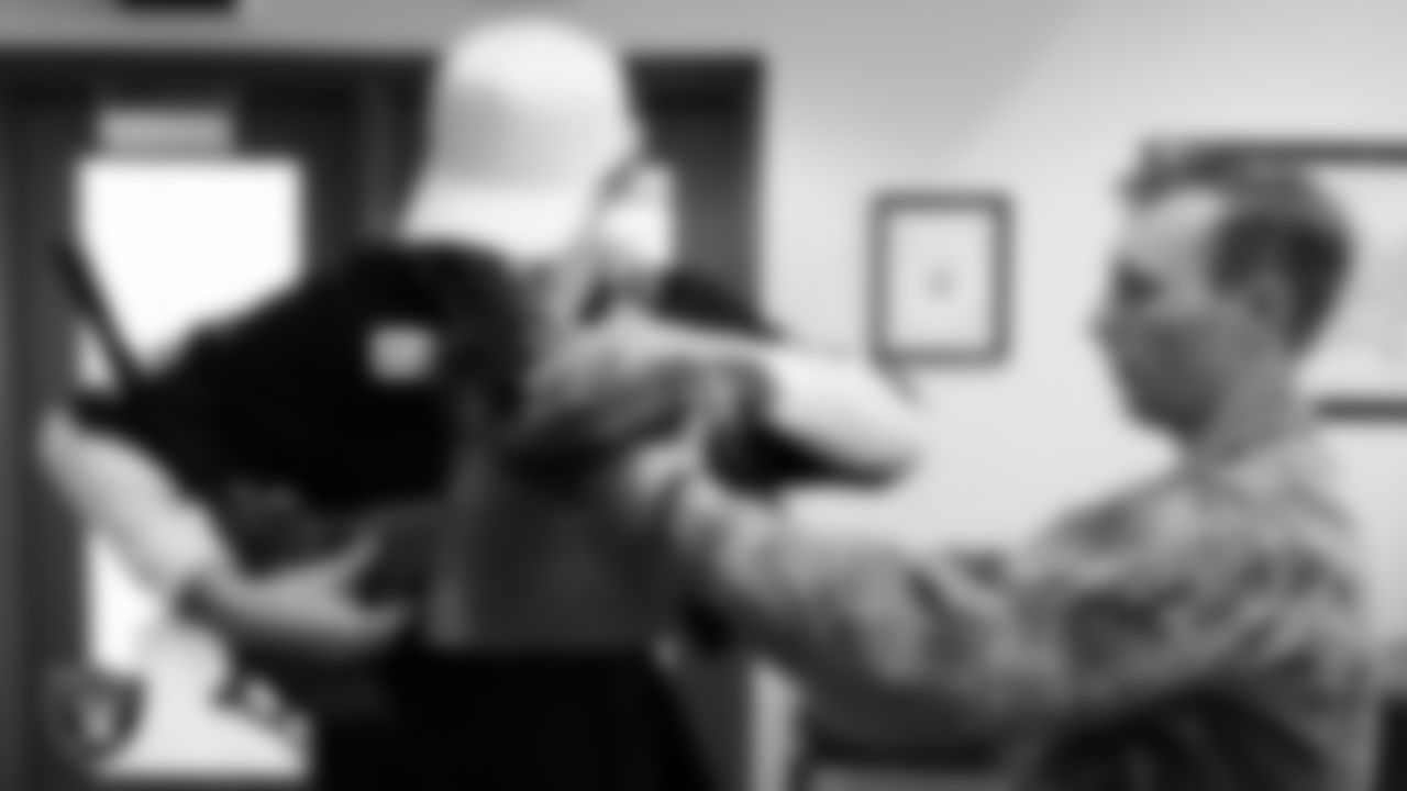 Las Vegas Raiders kicker Daniel Carlson (8) tries on military equipment during a tour of Nellis Air Force Base.