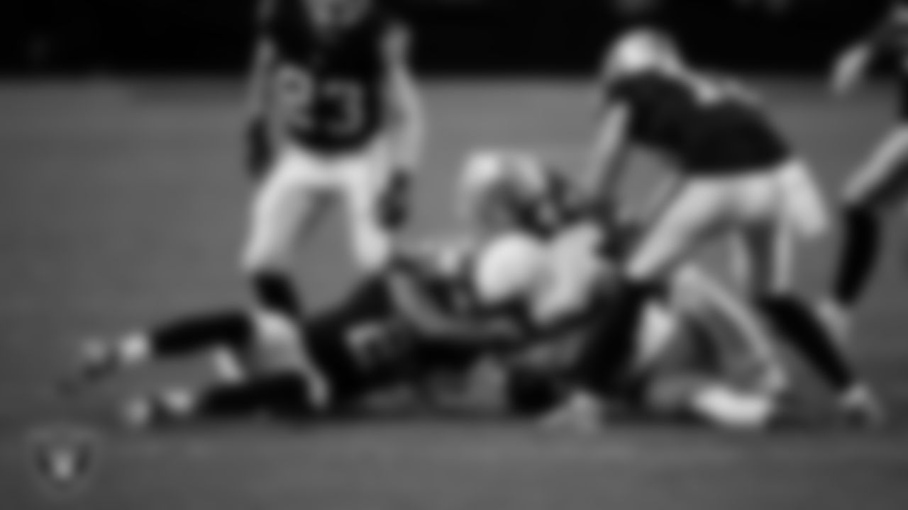 Las Vegas Raiders cornerback Decamerion Richardson (25) and linebacker Tommy Eichenberg (44) make a tackle during the regular season home game against the Cleveland Browns at Allegiant Stadium.