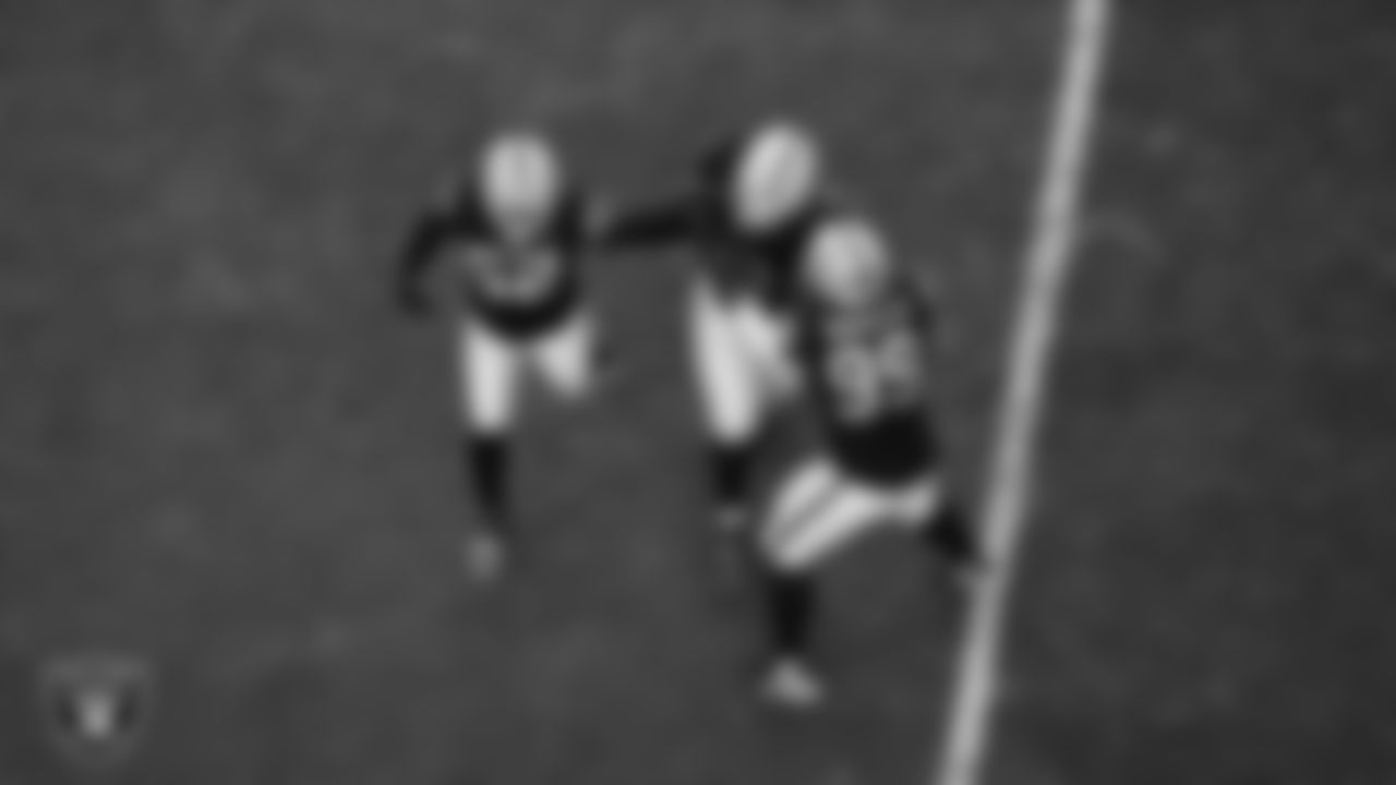 Las Vegas Raiders defensive tackle JJ Pegues (92) celebrates with linebacker Elandon Roberts (52) and defensive tackle Thomas Booker IV (99) after recovering a fumble during the regular season home game against the Kansas City Chiefs at Allegiant Stadium.