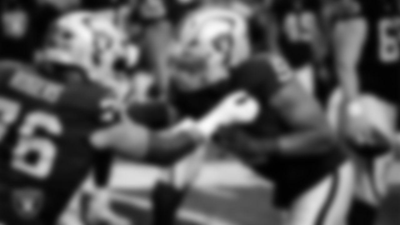 Las Vegas Raiders guard Caleb Rogers (76) and defensive end Tyree Wilson (9) warming up before the regular season home game against the Denver Broncos at Allegiant Stadium.