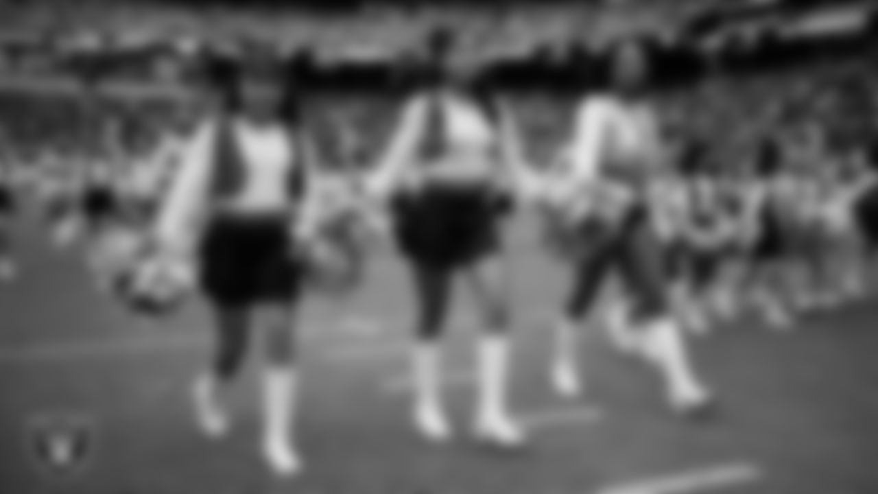 Raiderette Bria and Junior Raiderettes exit the field after their performance before the preseason home game against the San Francisco 49ers at Allegiant Stadium.