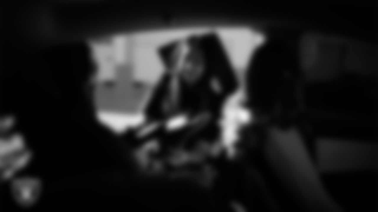 A Las Vegas Raiders ambassador loads equipment into a vehicle during the Raiders' Equipment Blitz at Intermountain Health Performance Center.