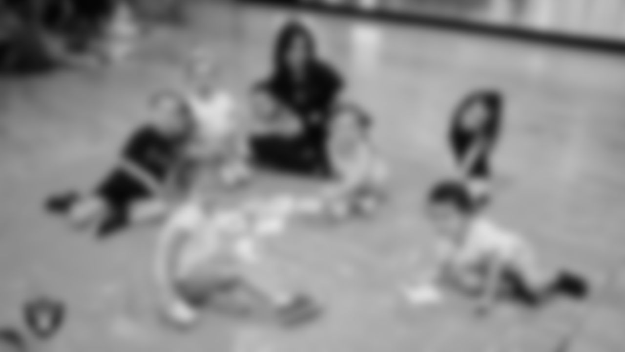 Raiderette Maddie poses for a photo with dancers during day one of summer camp at The Studio.