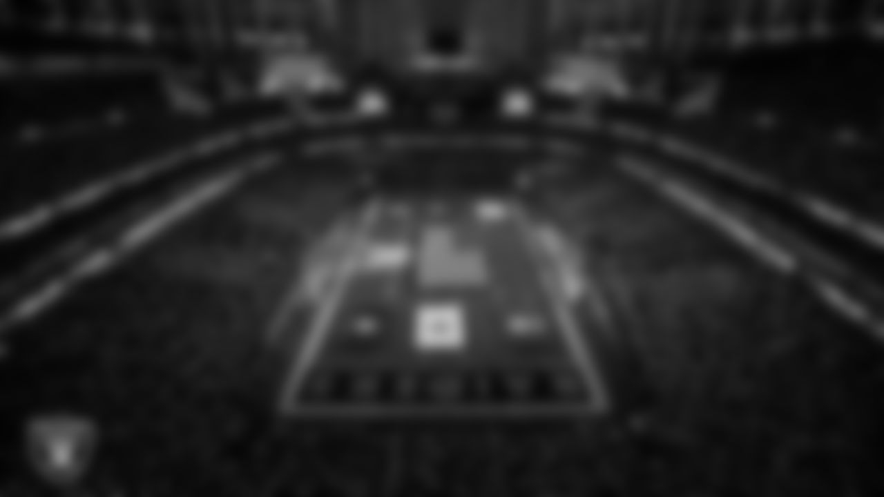 The American flag and military branch flags are displayed by Personal Seat License (PSL) holders on the field during the national anthem before the Las Vegas Raiders' regular season home game against the Dallas Cowboys at Allegiant Stadium.
