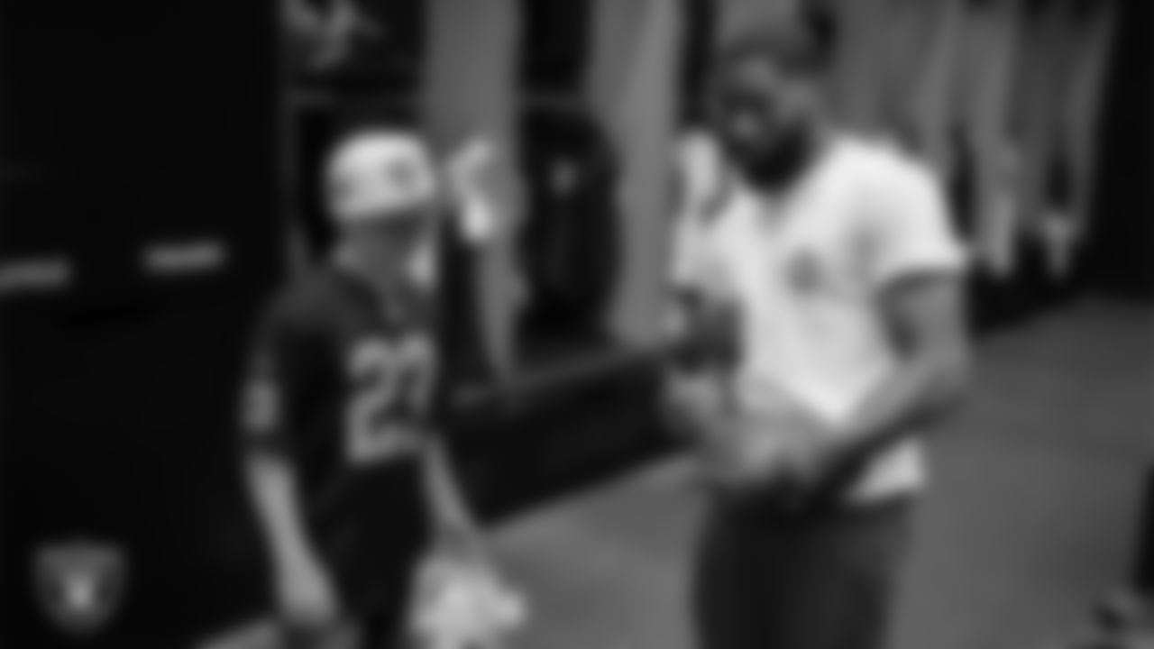 Tristen Golden from the Make-A-Wish Foundation gets a football signed by Las Vegas Raiders cornerback Nate Hobbs (39) during a visit to Intermountain Health Performance Center.