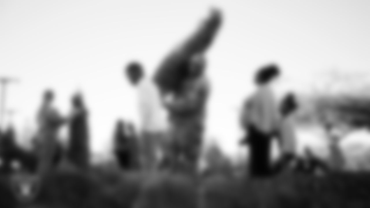 Air Force members and their families pick out a tree during the Raiders Holiday Salute at Nellis Air Force Base - Coral Academy.