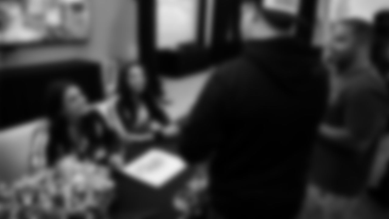 Raiderettes Annalise and Bria sign autographs for service members at Nellis Air Force Base.