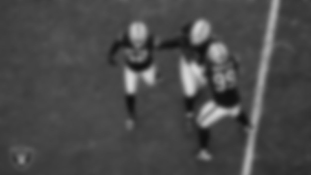 Las Vegas Raiders defensive tackle JJ Pegues (92) celebrates with linebacker Elandon Roberts (52) and defensive tackle Thomas Booker IV (99) after recovering a fumble during the regular season home game against the Kansas City Chiefs at Allegiant Stadium.