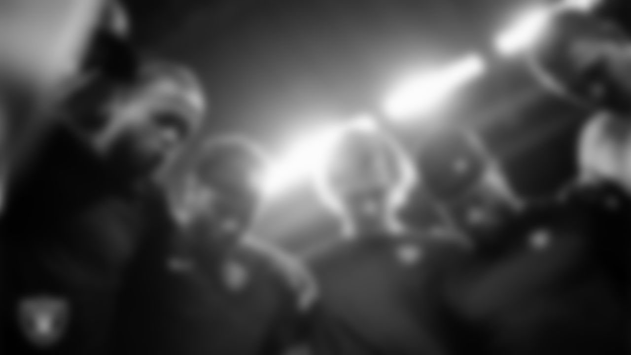 The Las Vegas Raiders quarterbacks and wide receivers huddle before the regular season away game against the Indianapolis Colts at Lucas Oil Stadium.