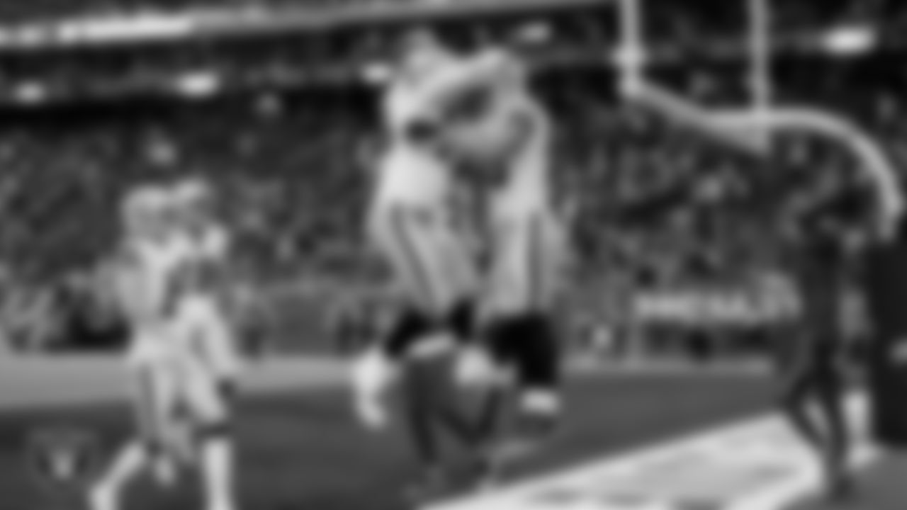 Las Vegas Raiders tight end Brock Bowers (89) celebrates with guard Caleb Rogers (76) after making a 7-yard touchdown catch during the regular season away game against the Houston Texans at NRG Stadium.