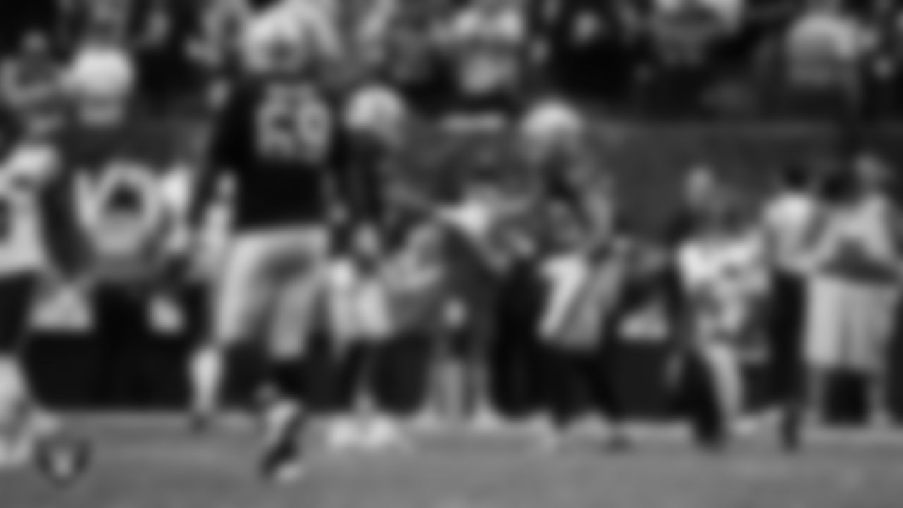 Las Vegas Raiders safety Jeremy Chinn (11) and safety Isaiah Pola-Mao (20) high-five on the field during the regular season home game against the Chicago Bears at Allegiant Stadium.