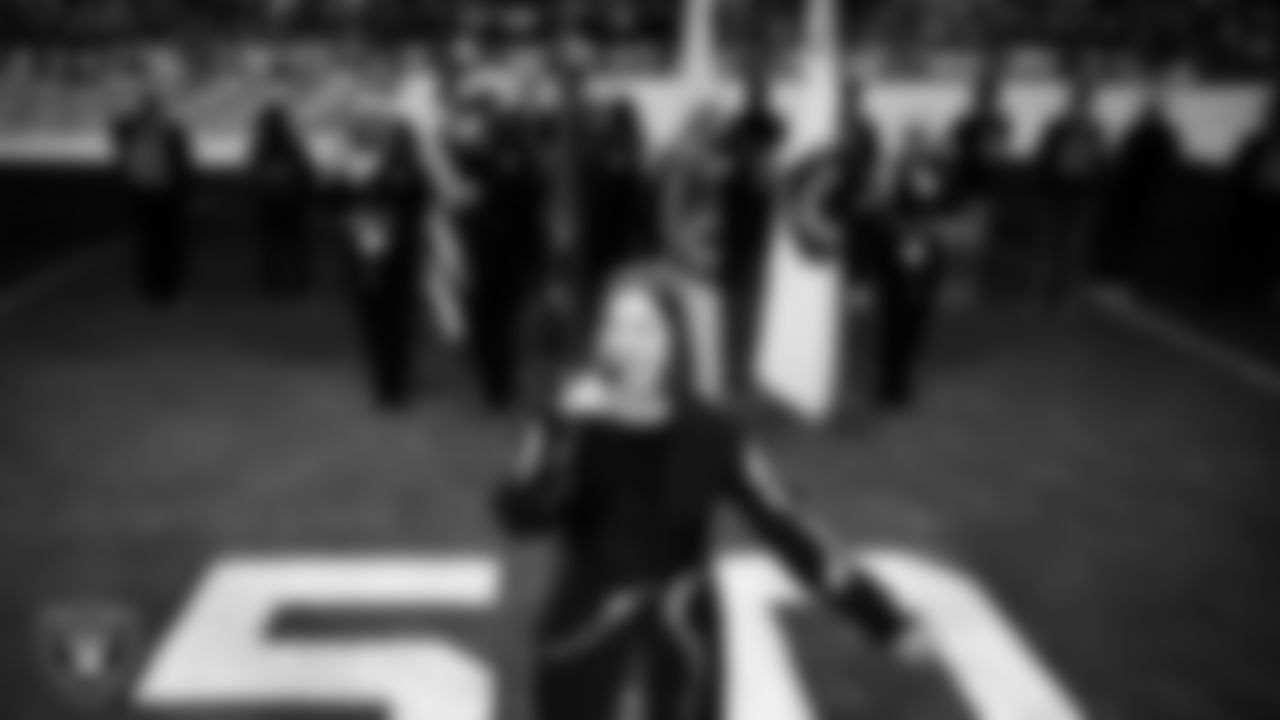 Singer Cassadee Pope performs the national anthem while the Clark County Fire Department Honor Guard presents the nation's colors before the Las Vegas Raiders' regular season home game against the Cleveland Browns at Allegiant Stadium.