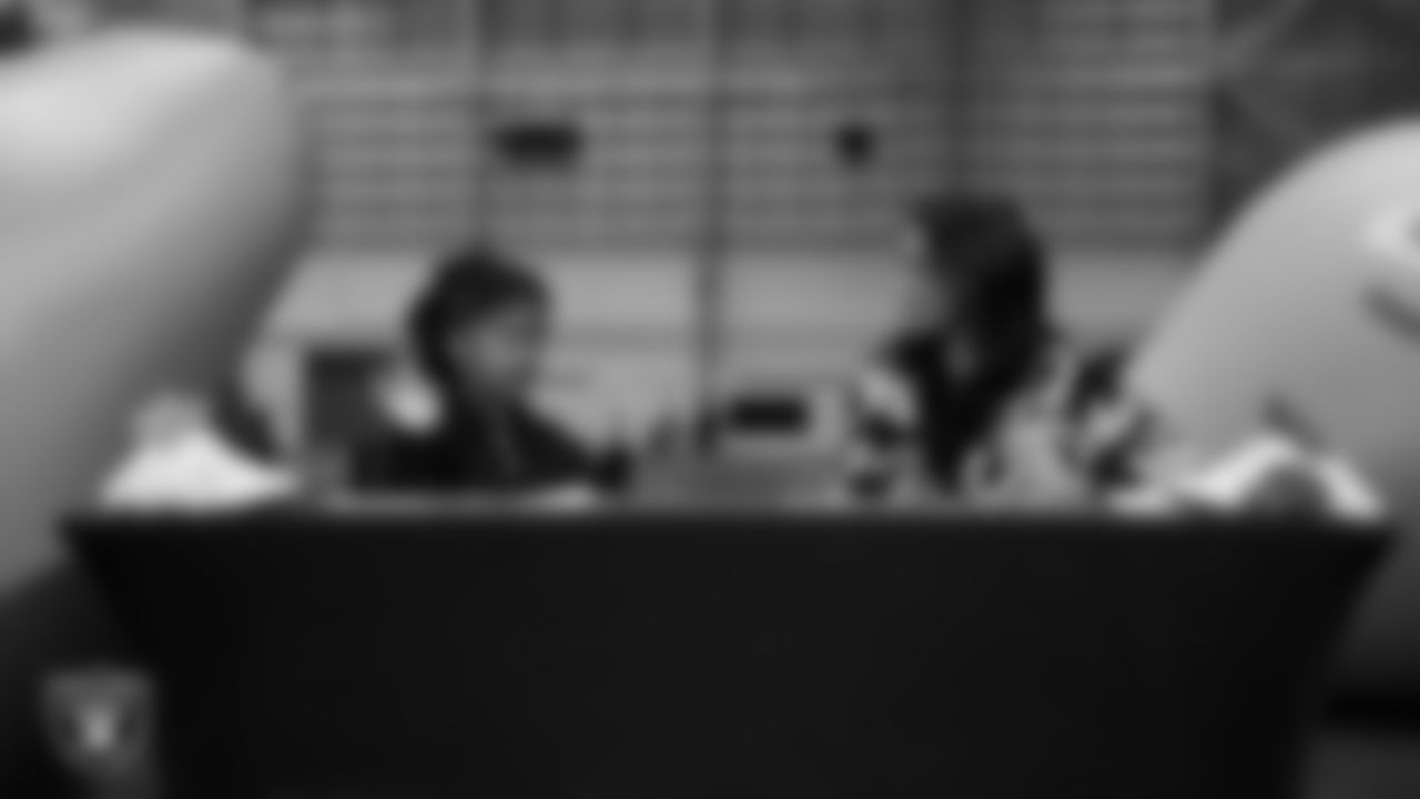 Las Vegas Raiders President Sandra Douglass Morgan designs custom shoes for My Cause My Cleats with Intermountain Children's Health patient Evelyn at Intermountain Health Performance Center.