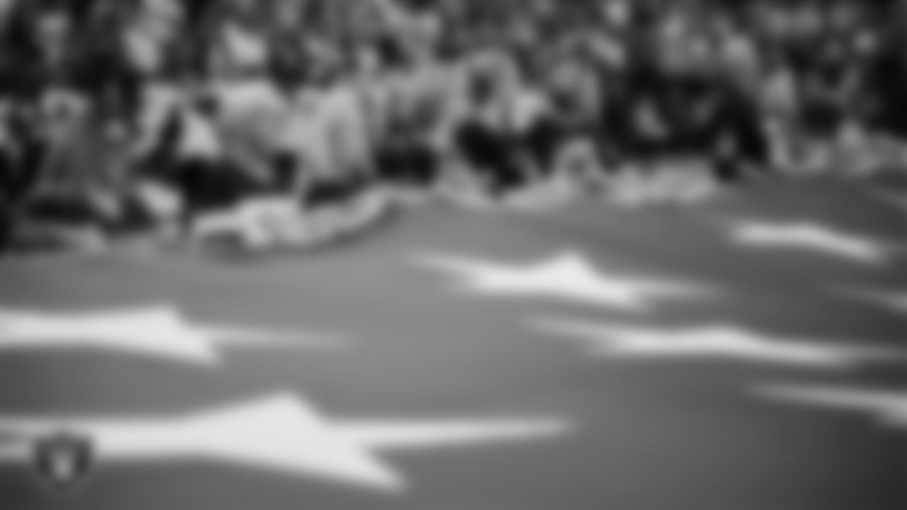 The American flag is displayed by Personal Seat License (PSL) holders on the field during the national anthem before the Las Vegas Raiders' regular season home game against the Jacksonville Jaguars at Allegiant Stadium.