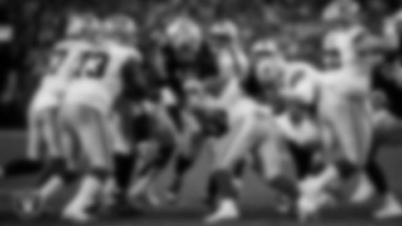 Las Vegas Raiders defensive tackle Adam Butler (69) and defensive tackle Jonah Laulu (96) make a tackle during the regular season home game against the Dallas Cowboys at Allegiant Stadium.