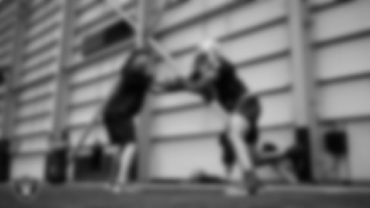 Las Vegas Raiders run game coordinator/defensive line coach Rob Leonard and defensive end Tyree Wilson (9) at an Organized Team Activity (OTA) at Intermountain Health Performance Center.