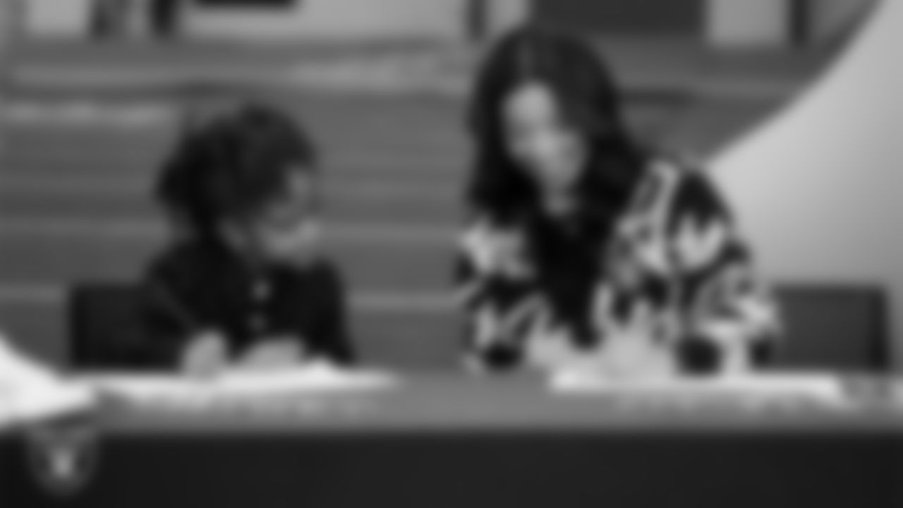 Las Vegas Raiders President Sandra Douglass Morgan designs custom shoes for My Cause My Cleats with Intermountain Children's Health patient Evelyn at Intermountain Health Performance Center.