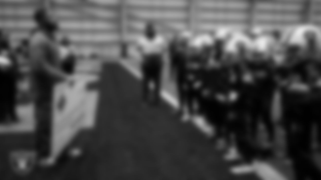 Las Vegas Raiders coordinator of football development Chris Shelby presents athletes with a check to go towards their travels for nationals during an open practice at Intermountain Health Performance Center.