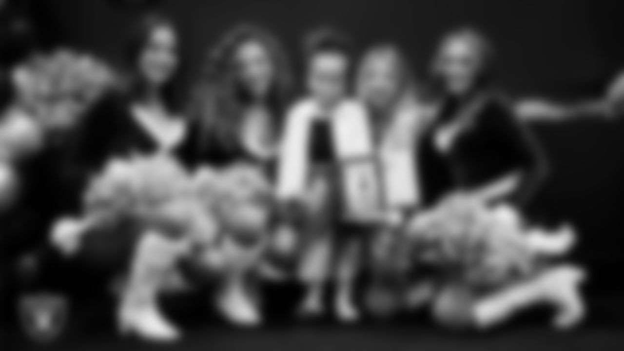 Raiderettes pose for a photo with a Junior Raiderette during the Junior Raiderettes Banquet at The Studio.