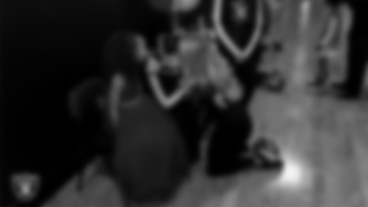 Raiderette Delaney does an attendee's makeup during the Valentine's Day Dance at The Studio.