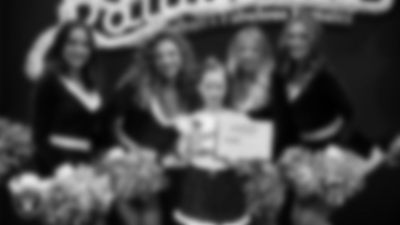 Raiderettes pose for a photo with a Junior Raiderette during the Junior Raiderettes Banquet at The Studio.