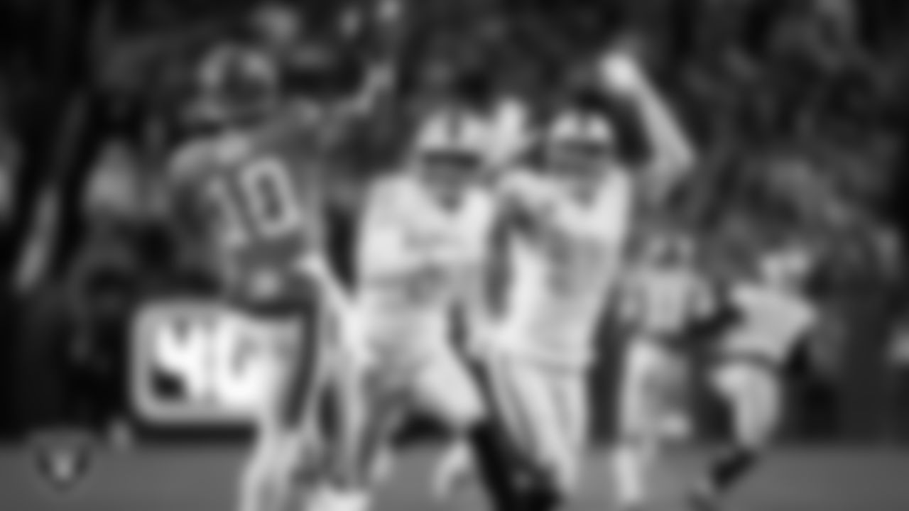 Las Vegas Raiders defensive end Charles Snowden (49) and defensive end Maxx Crosby (98) pressure the quarterback during the regular season away game against the Denver Broncos at Empower Field at Mile High.