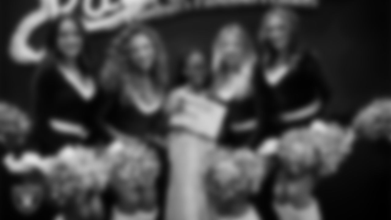 Raiderettes pose for a photo with a Junior Raiderette during the Junior Raiderettes Banquet at The Studio.