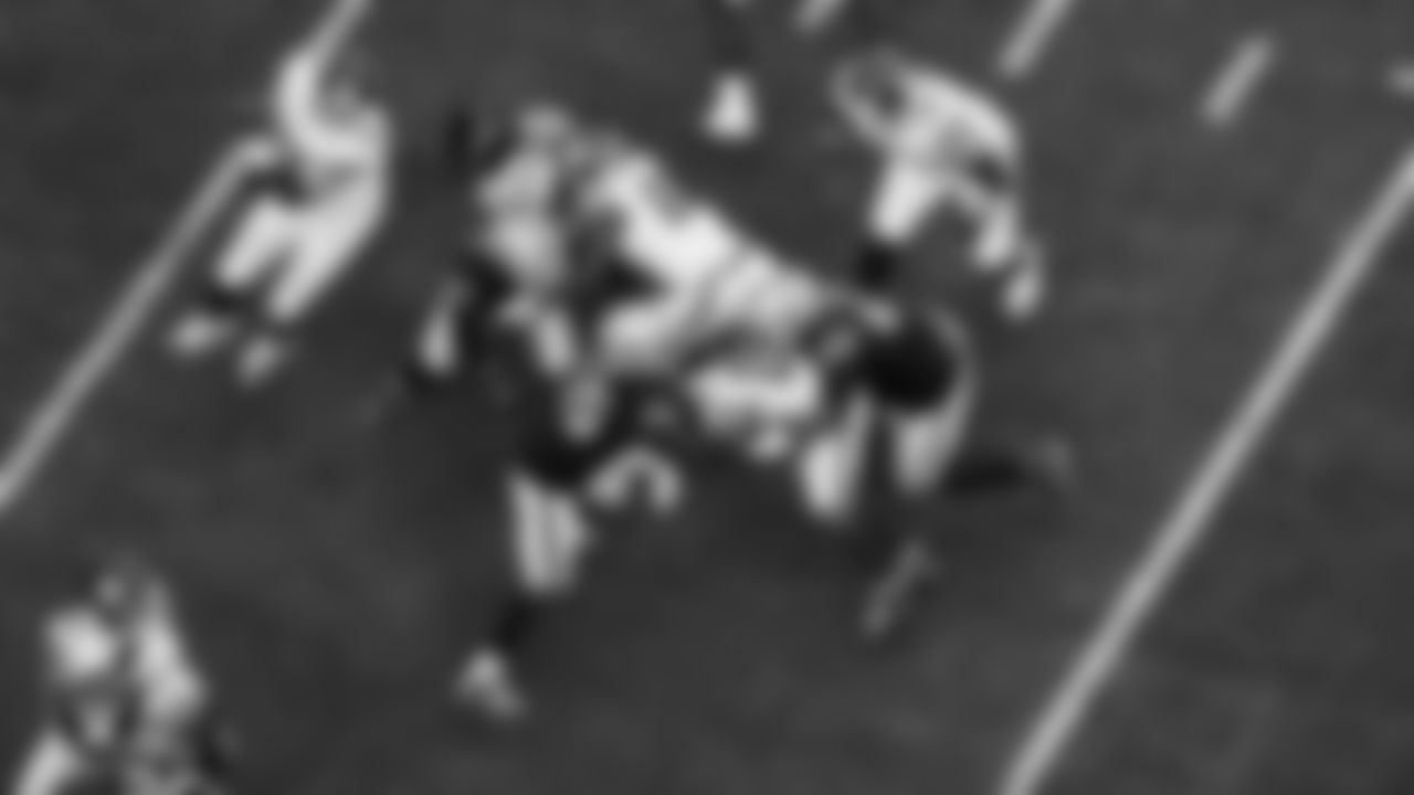 Las Vegas Raiders linebacker Devin White (45) and defensive tackle Adam Butler (69) make a tackle during the regular season home game against the New York Giants at Allegiant Stadium.