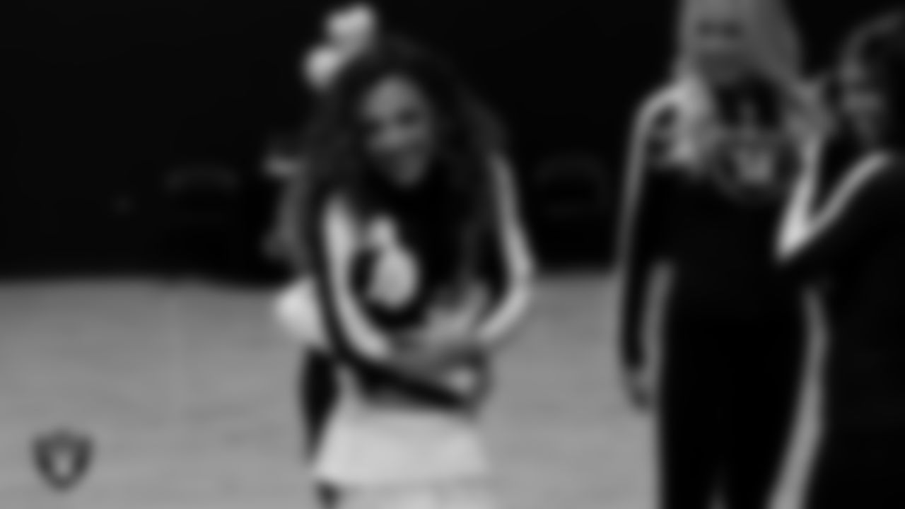 Raiderette Lexie welcomes an attendee to the Valentine's Day Dance at The Studio.