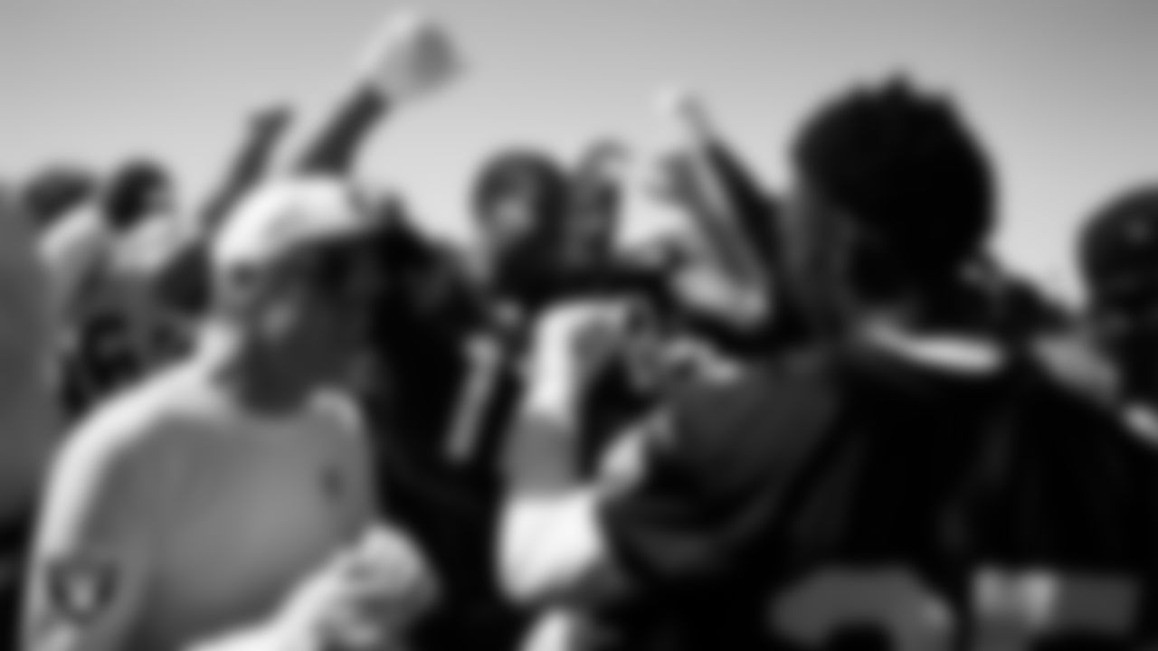 The Las Vegas Raiders huddle at a workout during phase two of the offseason program at Intermountain Health Performance Center.