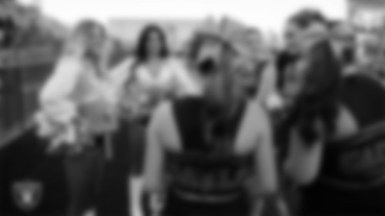 Raiderettes Jordie and Annalise speak with members of the Bishop Gorman High School cheer team before the Las Vegas Raiders' Football Showcase game at Bishop Gorman High School.