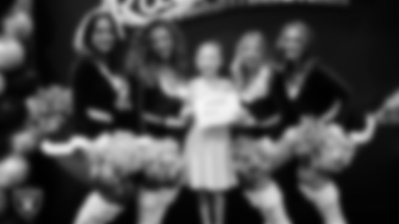 Raiderettes pose for a photo with a Junior Raiderette during the Junior Raiderettes Banquet at The Studio.