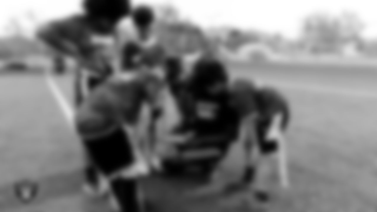 Athletes huddle with their coach during a Silver and Black League championship game at Teton Trails Soccer Complex.