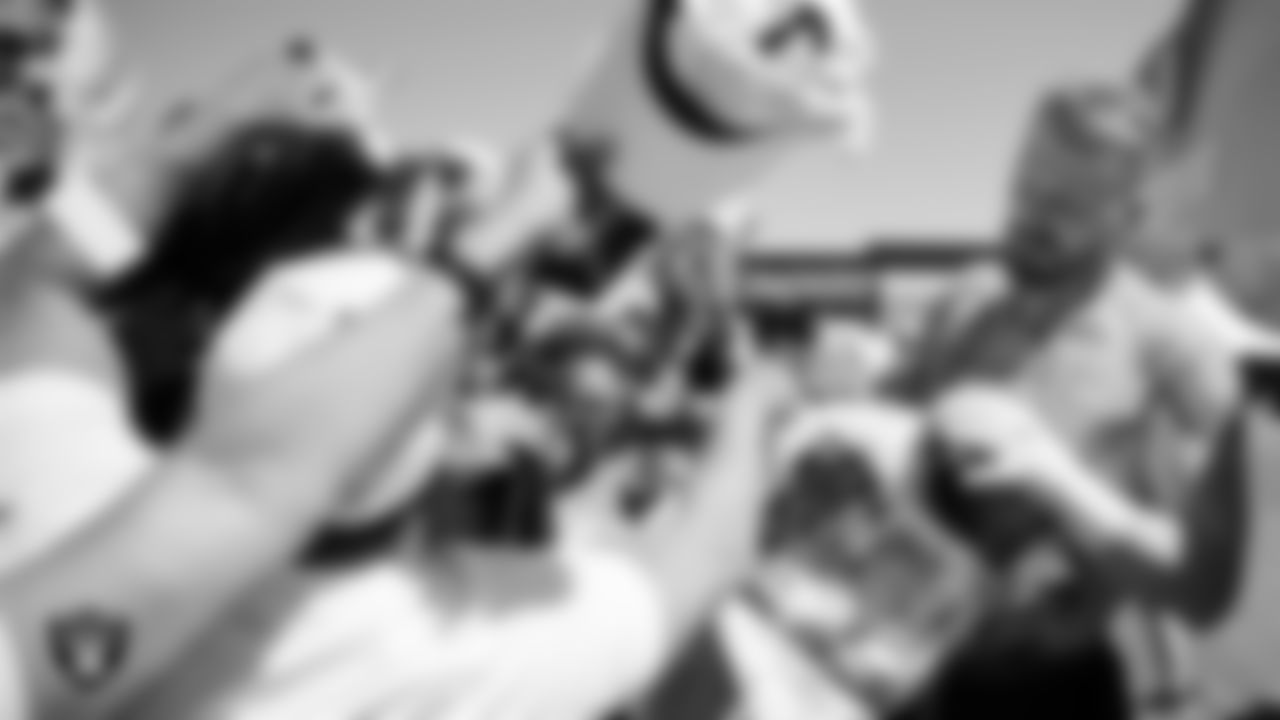 Las Vegas Raiders defensive end Maxx Crosby (98) signs autographs after a 2025 Training Camp practice at Intermountain Health Performance Center.