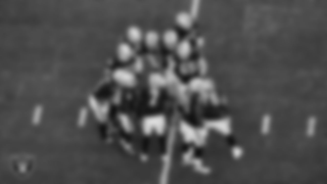 The Las Vegas Raiders offense huddles during the regular season home game against the Denver Broncos at Allegiant Stadium.