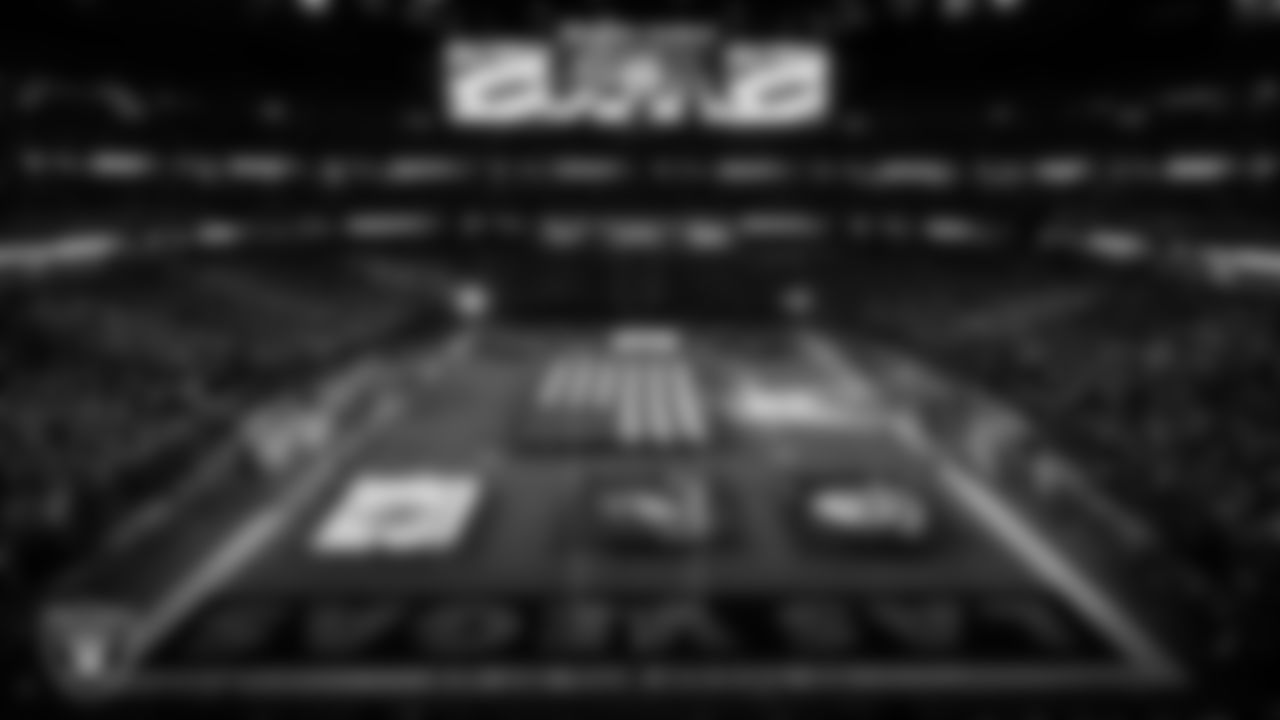 The American flag and military branch flags are displayed by Personal Seat License (PSL) holders on the field during the national anthem before the Las Vegas Raiders' regular season home game against the Dallas Cowboys at Allegiant Stadium.