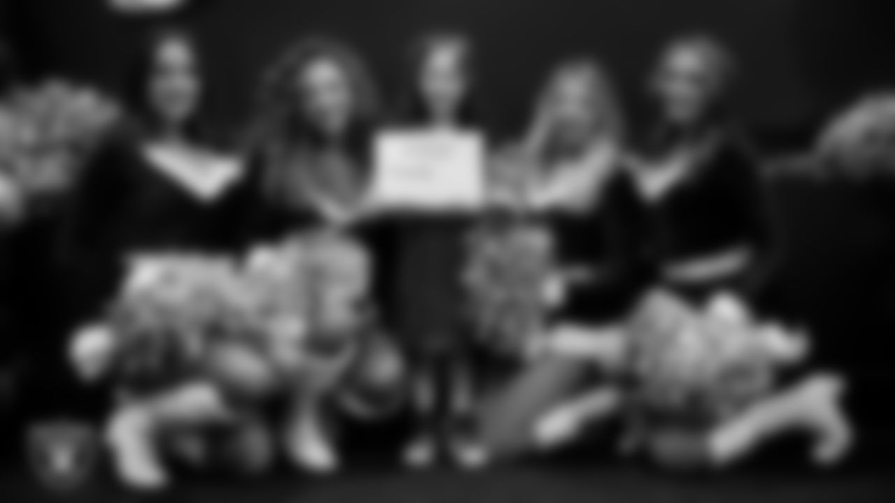 Raiderettes pose for a photo with a Junior Raiderette during the Junior Raiderettes Banquet at The Studio.