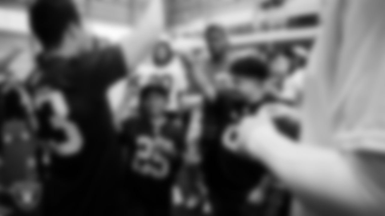 Christopher Arias and Marcos Carrillo from Make-A-Wish huddle with the team after practice during a visit to Intermountain Health Performance Center.