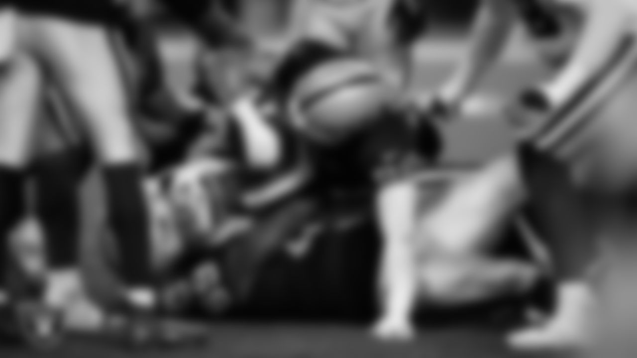 Las Vegas Raiders defensive tackle Adam Butler (69) and defensive end Maxx Crosby (98) make a tackle during the regular season home game against the Dallas Cowboys at Allegiant Stadium.