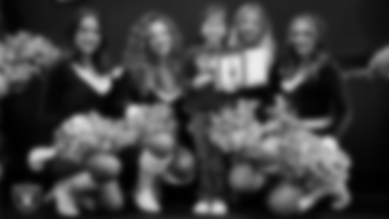 Raiderettes pose for a photo with a Junior Raiderette during the Junior Raiderettes Banquet at The Studio.