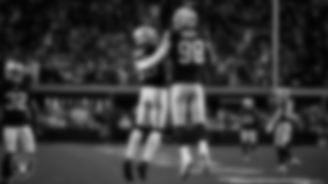 Las Vegas Raiders defensive end Maxx Crosby (98) celebrates with linebacker Jamal Adams (33) after forcing a fumble during the regular season home game against the Dallas Cowboys at Allegiant Stadium.