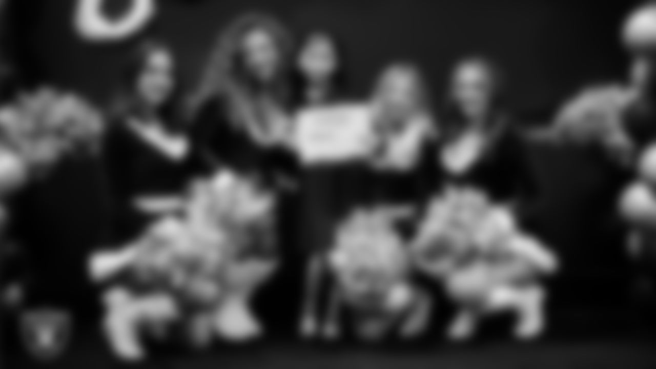 Raiderettes pose for a photo with a Junior Raiderette during the Junior Raiderettes Banquet at The Studio.