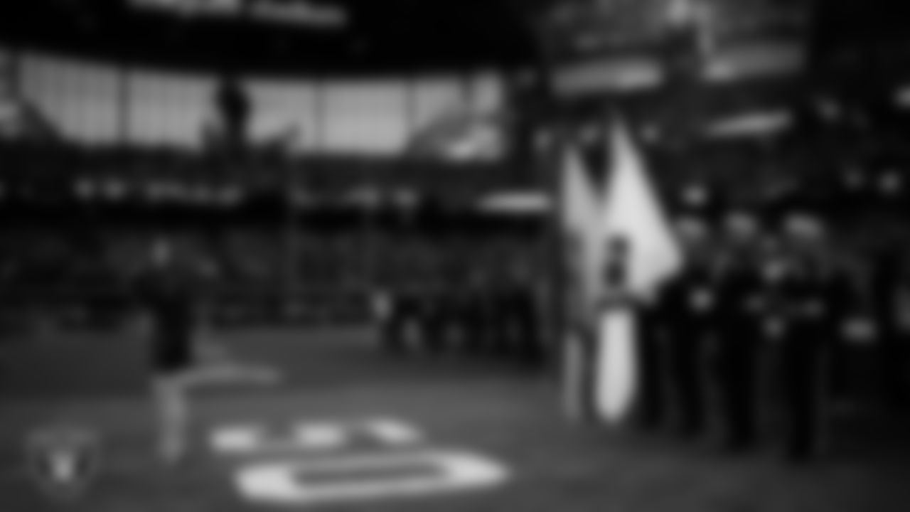 Singer Cassadee Pope performs the national anthem while the Clark County Fire Department Honor Guard presents the nation's colors before the Las Vegas Raiders' regular season home game against the Cleveland Browns at Allegiant Stadium.