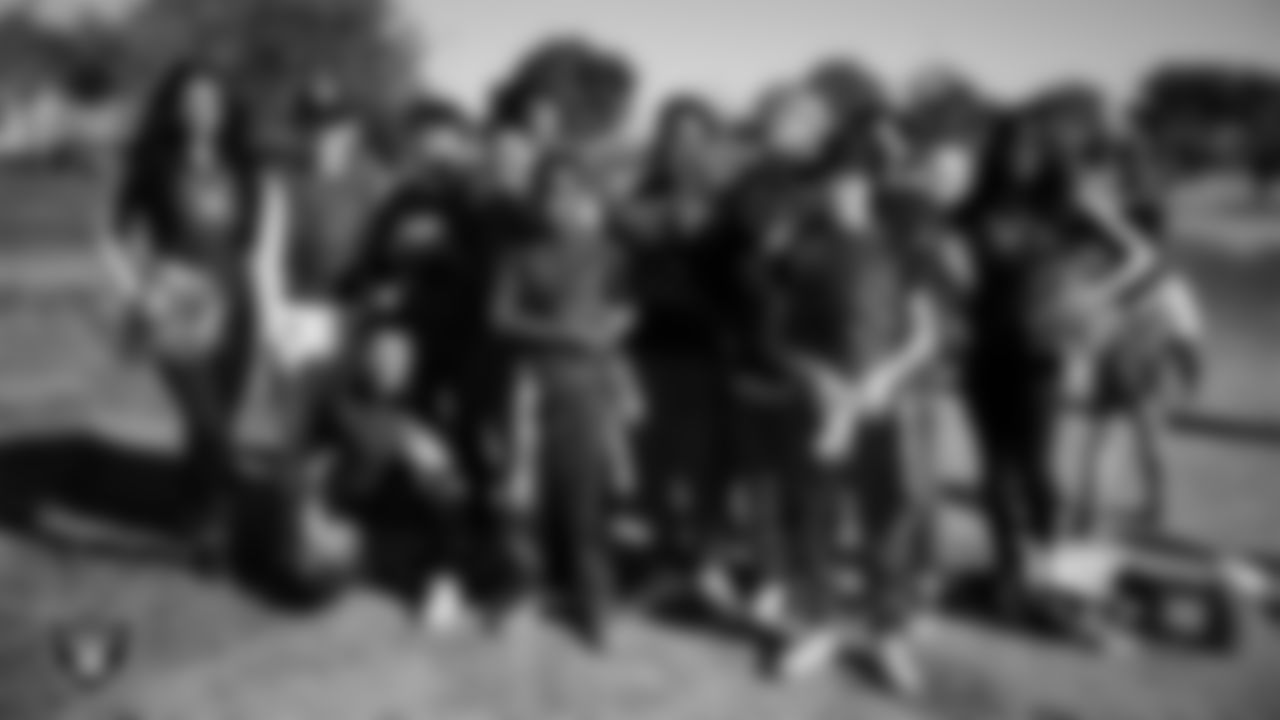 Raiderettes Kylee and Sloane pose for a photo with athletes during the LEEAP Flag Football Tournament at Desert Breeze Park.