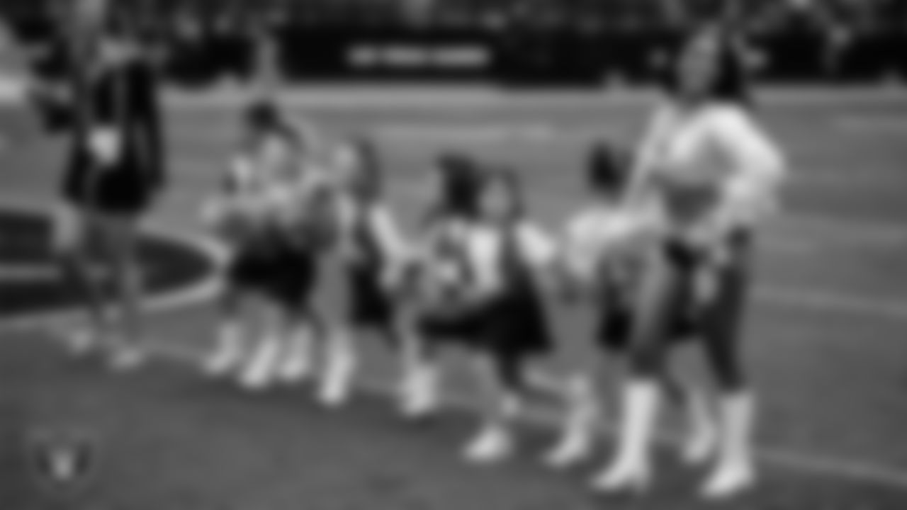 Raiderette Kylie and Junior Raiderettes exit the field after their performance before the preseason home game against the San Francisco 49ers at Allegiant Stadium.