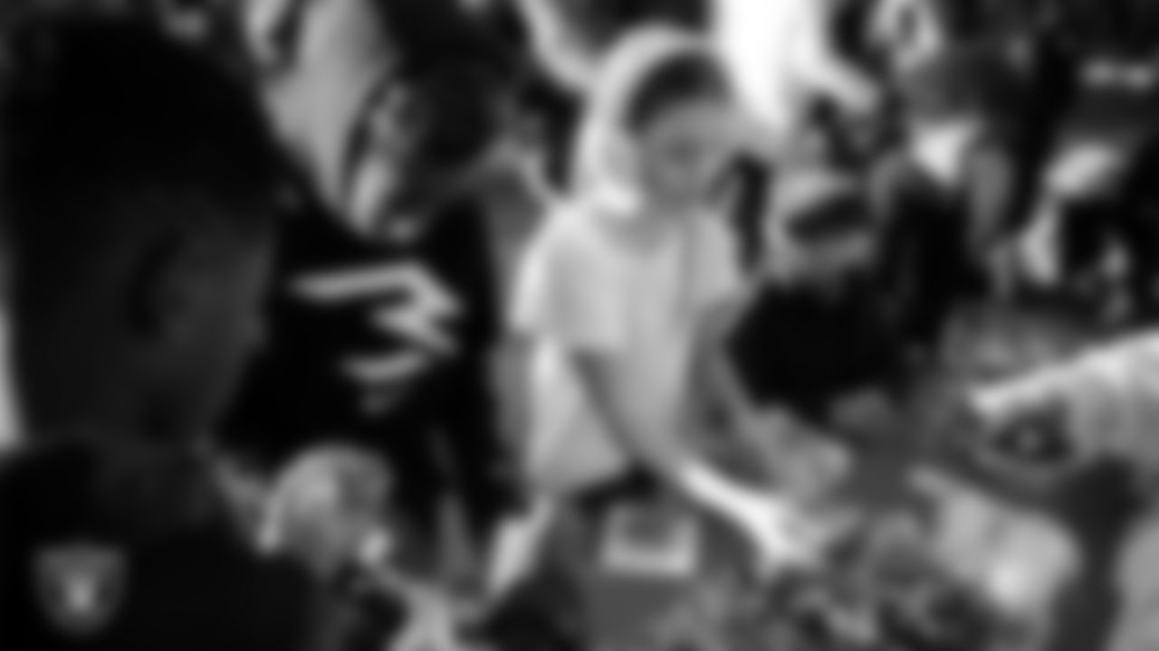 Children decorate ornaments during the Raiders Holiday Salute at Nellis Air Force Base - Coral Academy.